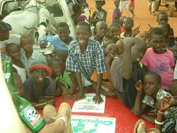 African children with Plymouth Banjul poster..   Now don't forget to donate...